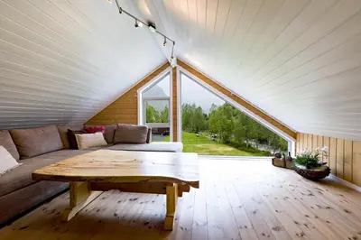 a living room with a couch and a table at Riverside in Hornindal