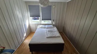 two beds in a room with a window at Trolltunga Lodge in Odda