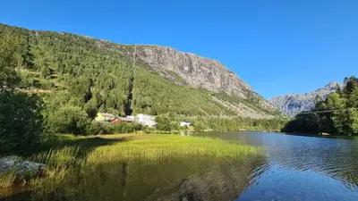 a view of a river with a mountain in the background at Trolltunga Lodge in Odda