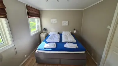a small bedroom with two beds in it at Trolltunga Lodge in Odda