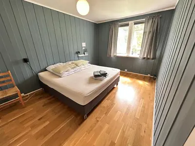 a bedroom with a bed and a window at Trolltunga Lodge in Odda