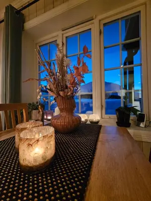 a table with a vase on top of a table at Leilighet Gaustablikk in Rjukan
