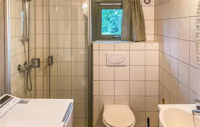 a bathroom with a toilet and a shower and a sink at 3 Bedroom Amazing Home In Sjusjøen in Sjusjøen