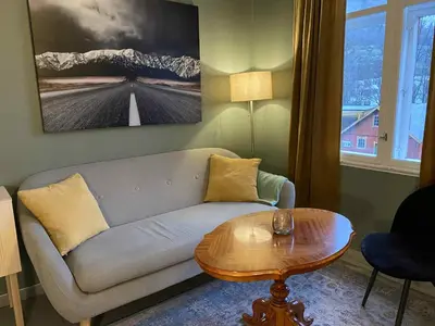 a living room with a couch and a table at Lærdalsøren Motor Guesthouse in Lærdalsøyri
