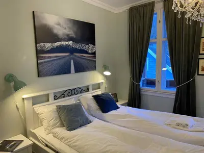 a bedroom with two beds and a large window at Lærdalsøren Motor Guesthouse in Lærdalsøyri