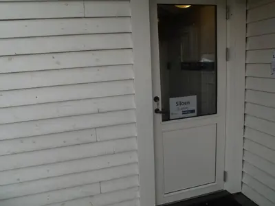 a door with a sign on it on a house at Siloen - cosy apartment in Herand in Herand