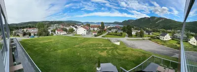 an aerial view of a small town on a grassy hill at Hotell Koselig in Kyrksæterøra