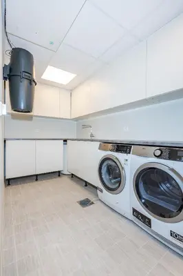 a laundry room with a washer and dryer at Modern Apartment with panorama wiew in Blakset