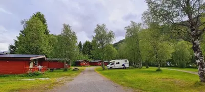 a campsite with a van parked in the grass at Romsdalseggen Camping in Isfjorden