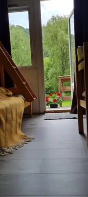 an open door with a view of a garden at Romsdalseggen Camping in Isfjorden