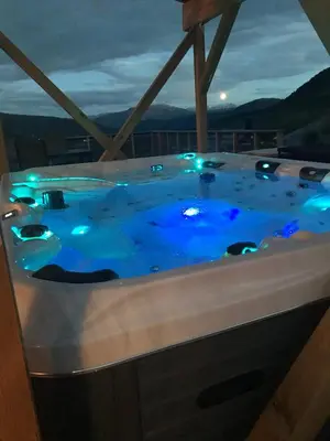 a jacuzzi tub with blue lights in a room at Pudderhytta in Sogndal