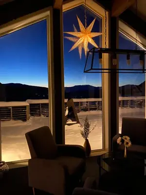 a living room with a star hanging from a window at Pudderhytta in Sogndal