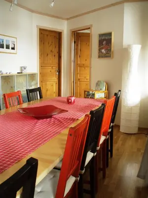 a dining room table with a red tablecloth and chairs at Nystuen in Tyinkrysset