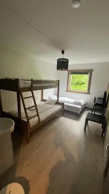 a room with two bunk beds and a window at BUDGET Kvamseter Lodge in Eikedalen