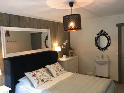 a bedroom with a bed with a mirror and a sink at BUDGET Kvamseter Lodge in Eikedalen