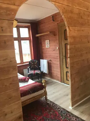 a room with an archway in a wooden house at Eidfjord Gjestgiveri in Eidfjord