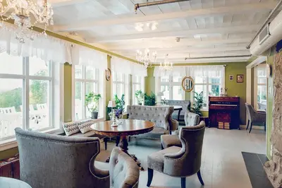 a living room with a table and chairs at Haaheim Gaard in Uggdal