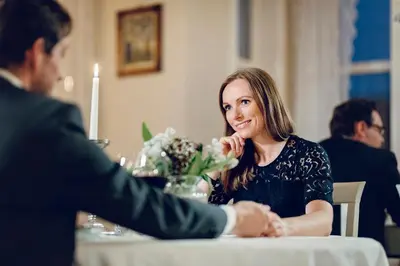 a woman sitting at a table with a man at Haaheim Gaard in Uggdal