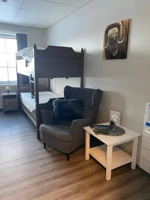 a living room with a chair and a bunk bed at Basecamp Frich`s Hjerkinn in Hjerkinn