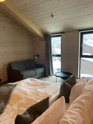 a bedroom with a large bed and a couch at BrimiBue Hotel in Lom