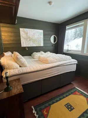 a large bed in a room with a window at Storehorn Apartments Hemsedal in Hemsedal