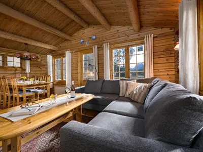 a living room with a couch and a table at Chalet Fjordblick I by Interhome in Olden