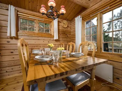 a dining room with a wooden table and chairs at Chalet Fjordblick I by Interhome in Olden