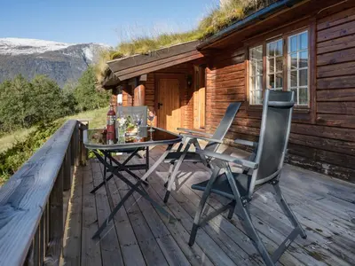 a deck with a table and chairs on a cabin at Chalet Fjordblick I by Interhome in Olden