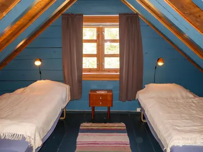two beds in a room with a window at Holiday Home Rabbane by Interhome in Nyttingsnes