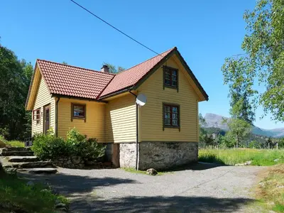 a small yellow house with a red roof at Holiday Home Rabbane by Interhome in Nyttingsnes