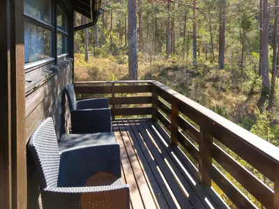 a porch of a cabin with two chairs on it at Holiday Home Sandvikfjellet by Interhome in Nyttingsnes