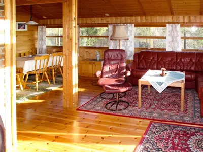 a living room with a couch and a table at Holiday Home Sandvikfjellet by Interhome in Nyttingsnes