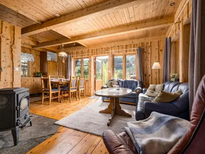 a living room with a couch and a table and a stove at Holiday Home Lona by Interhome in Viksdalen