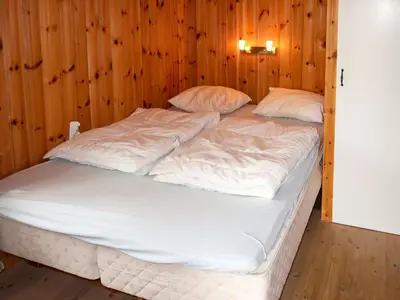 a large bed in a room with wooden walls at Holiday Home Havsblikk by Interhome in England