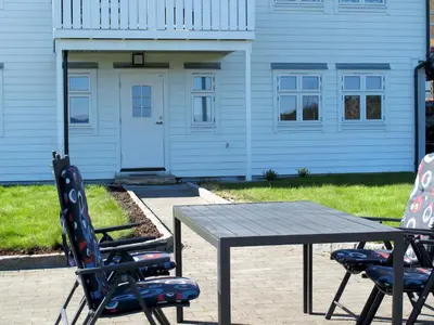 two chairs and a table in front of a house at Apartment Galanten by Interhome in Lunde