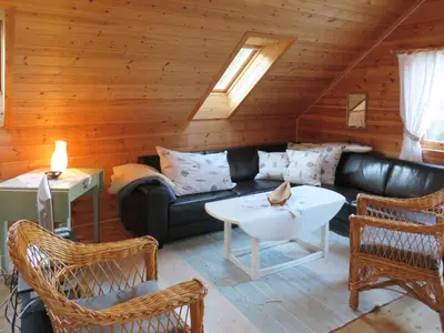 a living room with a black leather couch and chairs at Holiday Home Tufto by Interhome in Lunde