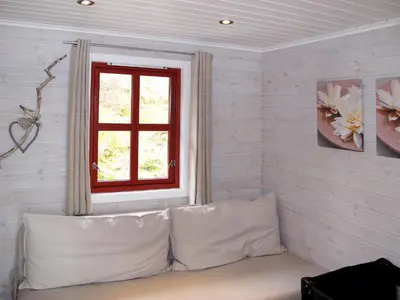 a couch in a room with a window at Holiday Home Elistova by Interhome in Onarheim