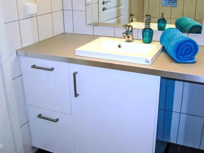 a bathroom with a white sink and a mirror at Apartment Rorbuen by Interhome in Uggdal