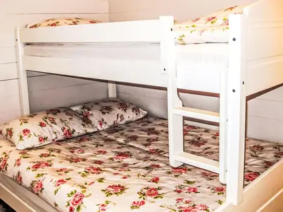 a bedroom with two bunk beds with pillows at Apartment Rorbuen by Interhome in Uggdal