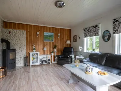 a living room with a couch and a table at Chalet Gulehuset by Interhome in Gjelland