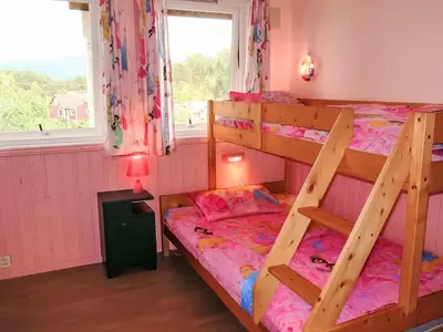 a bedroom with two bunk beds and a window at Holiday Home Gule huset by Interhome in Bruntveit