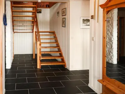 a staircase in a room with a black tile floor at Holiday Home Gule huset by Interhome in Bruntveit