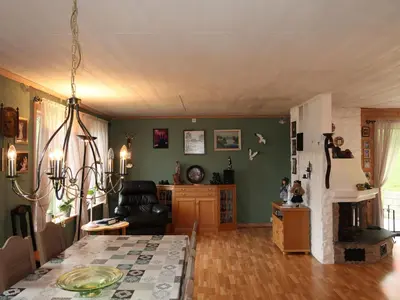 a living room with a table and a fireplace at Holiday Home Gule huset by Interhome in Bruntveit