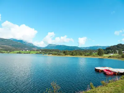 two boats on a lake with mountains in the background at Chalet Anna by Interhome in Eikelandsosen
