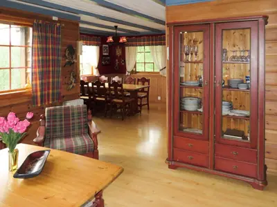 a living room with a table and a dining room at Chalet Anna by Interhome in Eikelandsosen