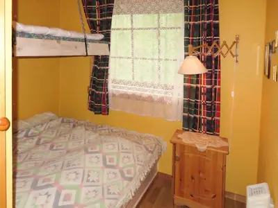 a bedroom with a bunk bed and a window at Chalet Anna by Interhome in Eikelandsosen