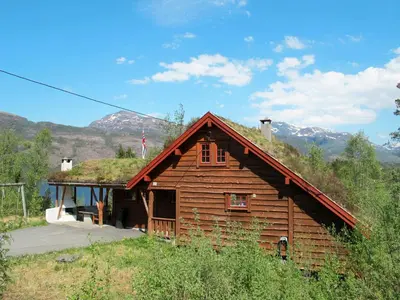 a log cabin with a grass roof at Chalet Elisabeth by Interhome in Eikelandsosen