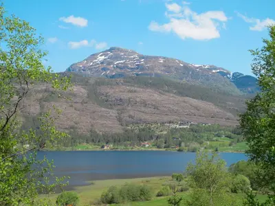 a view of a lake with a mountain in the background at Chalet Elisabeth by Interhome in Eikelandsosen