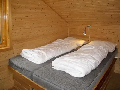 a sauna with two beds in a wooden cabin at Chalet Julie by Interhome in Eikelandsosen