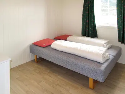 two pillows on a bench in a room with a window at Holiday Home Rød Hytte by Interhome in Herand